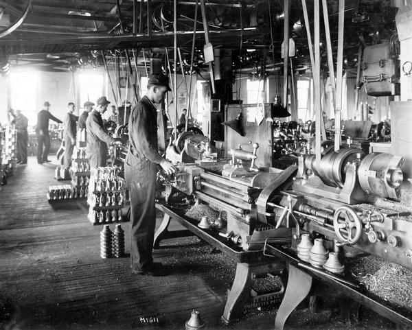 Factory workers using metal lathes to machine parts at International Harvester's Milwaukee Works. The factory was owned by the Milwaukee Harvester Company until 1902.