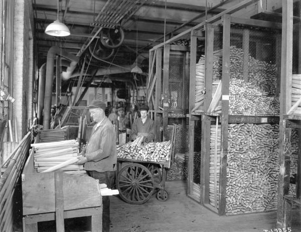 Workers handling spokes for wagon wheels at International Harvester's Weber Wagon Works. The factory was located at Auburn Park and was owned by the Weber Wagon Company until 1904. International Harvester continued to produce wagons at the factory until 1927.