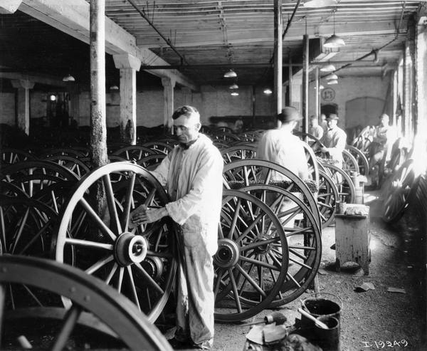 Workers sanding wagon wheels at International Harvester's Weber Wagon Works in Auburn Park. The factory was owned by the Weber Wagon Company until 1904, when it was purchased by International Harvester.
