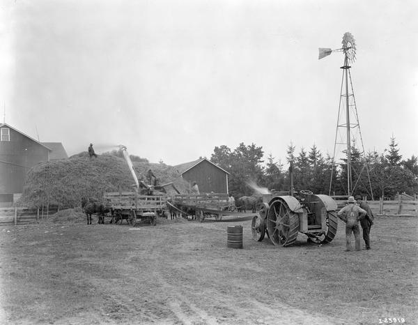 International 15-30 H.P tractor running an International 28 x 46 thresher on a rural farm.  The tractor was purchased by Oscar Krueger in 1920. The thresher was purchased by Mr. Krueger in 1921. He used the tractor and thresher for 11 silo filling and feed grinding jobs totaling 15,000 bushels in 1921.