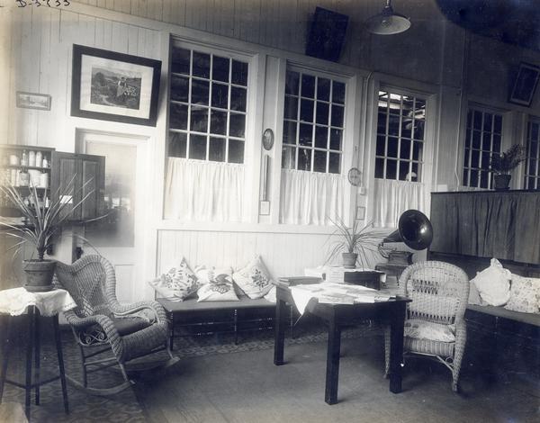 Wicker chairs, pillows, table, magazines, a Victrola, and a medicine cabinet in the infirmary at International Harvester' Deering Works twine mill. The factory was owned by the Deering Harvester Company until 1902, when it became part of International Harvester Company.