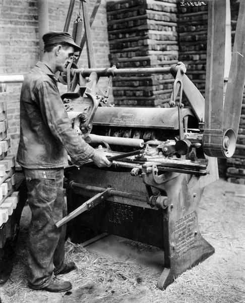 Worker turning a wagon wheel spoke on a belt-driven industrial lathe at International Harvester's Accurate Engineering Works.
