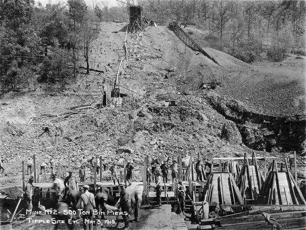 Men working around 500 ton bin piers and tipple site of mine no. 2. Benham was a "company town" created by International Harvester for the workers of the Wisconsin Steel Company. Wisconsin Steel was a subsidiary of International Harvester and operated coal mines at Benham.