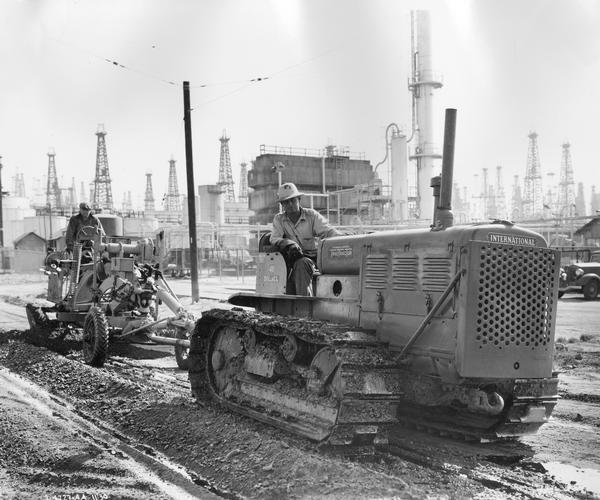 Road construction workers using an International TD-40 TracTracTor (crawler tractor) and an Adams Model 4 grader owned by the City of Signal Hill.