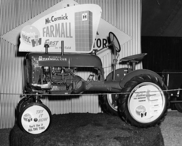 McCormick Farmall Cub tractor with "Mid-Century Promotion" advertising placards on hood and wheels. Similar placards were used on the limited edition White demonstrator tractors featured during the promotional campaign.