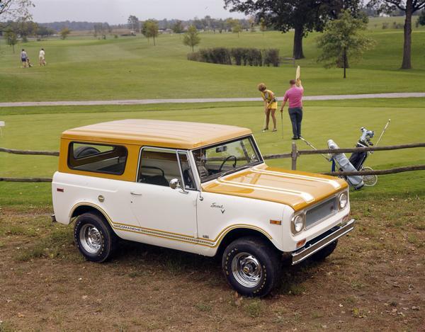 Color advertising photograph of a man and woman on a golf course green with an International Scout Comanche pickup in the foreground.