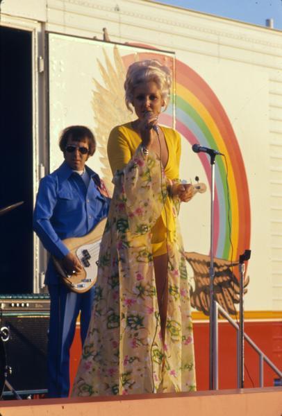 Bonnie Nelson (a.k.a. "Transtar Rose") singing country music with a band on her truck stop tour. The tour ran in the summer of 1975 from Omaha to Des Moines. The tour promoted International Transtar trucks.