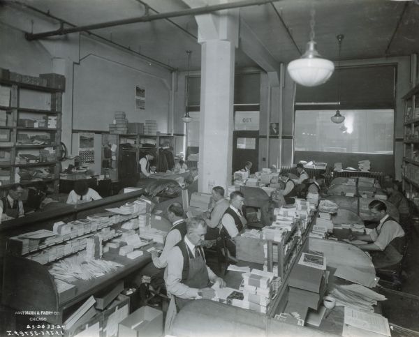 Men preparing publications at Harvester Press, International Harvester's in-house print shop.
