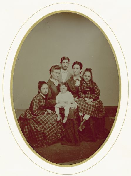 Tintype portrait of Nettie Fowler McCormick (1835-1923), with her four children: Mary Virginia McCormick (seated at left, 1861-1941), Cyrus Hall McCormick, Jr. (standing, 1859-1936), and Anita Eugenie McCormick (seated at right, 1866-1954).  An unidentified woman is holding the young Harold Fowler McCormick (1872-1941).