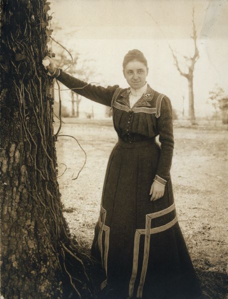 Mary Virginia McCormick (1861-1941) leaning with her arm on a tree. Mary Virginia was the daughter of Chicago industrialist and inventor, Cyrus Hall McCormick.