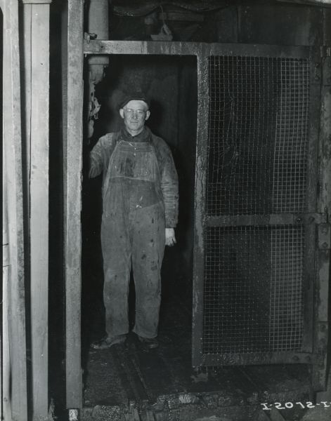 Worker in an elevator at International Harvester's Hawkins Mine near Hibbing, Minnesota.