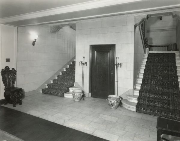 Lower Reception Hall (basement) stairs of Cyrus McCormick, Jr's residence at 50 East Huron Street. The original caption indicates that the view is "leading north toward south to ground floor -- and front door."