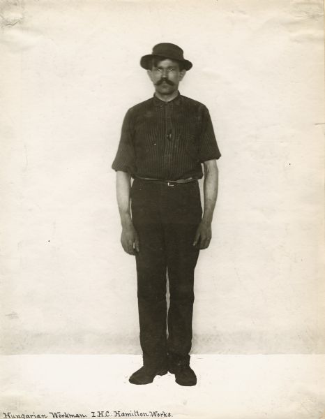 Full-length portrait of a "Hungarian" factory worker at International Harvester's Hamilton Works in Ontario, Canada.