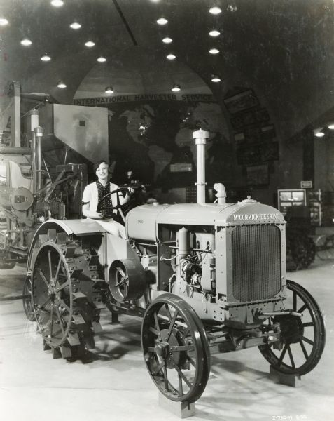 Queen of the "A Century of Progress" exhibition, Lillian Anderson of Racine, Wisconsin, poses behind the wheel of a McCormick-Deering W-30 tractor in the International Harvester exhibit.