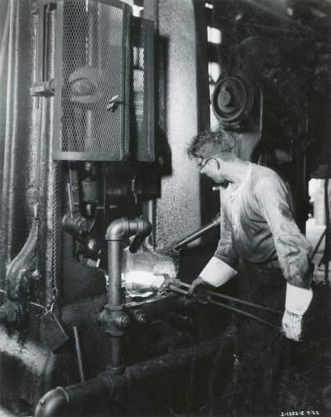 A factory worker in the dry forging area at the McCormick Works.