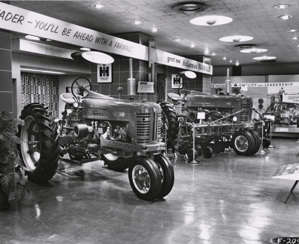 McCormick Farmall Tractors on Display A Farmall 300 and 400 tractor on display in a showroom. The showroom may have been at the International Harvester headquarters in Chicago, Illinois.