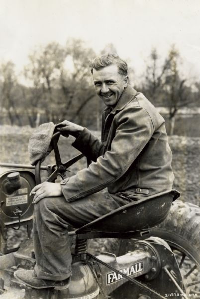 Milton Grafstrom on Tractor Milton Grafstrom sits behind the wheel of Clyde E. Shorey's Farmall tractor.