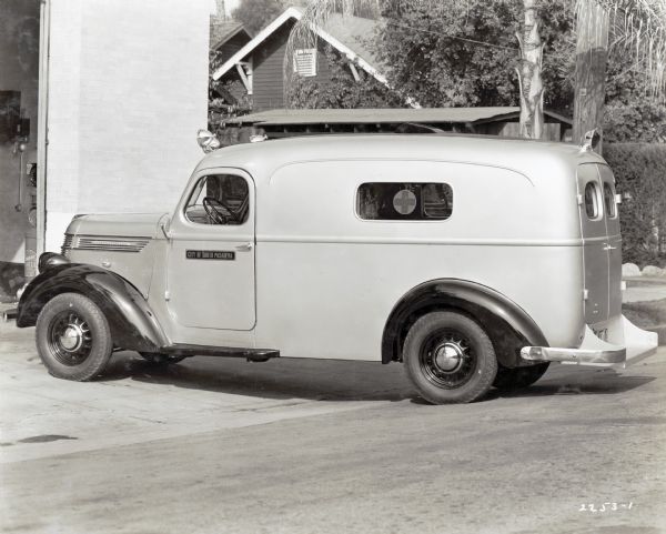 An International truck used as an ambulance by the City of South Pasadena parked outside of what appears to be the hospital garage.
