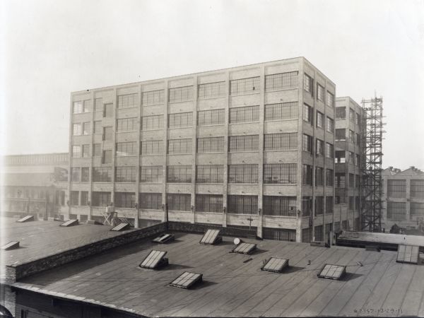 Milwaukee Works factory building which housed a six-story machine shop. Scaffolding runs the length of the right side of the building. The photograph was taken from an adjacent rooftop.