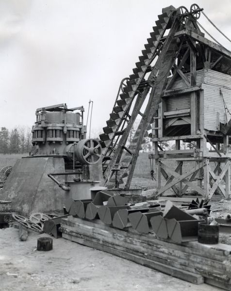 Simmons stone crusher powered by an International power unit at a State Highway Commission stone quarry.
