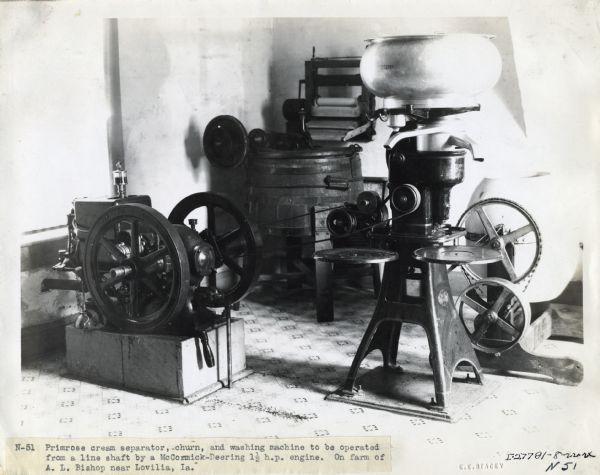 McCormick-Deering 1 1/2 h.p. engine powering a Primrose cream separator, a churn, and a washing machine on the farm of A.L. Bishop.