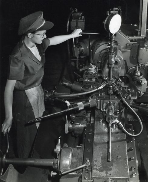 Factory worker Byrdine Fowler operates a grinder at International Harvester's St. Paul Works to take down the outer dimension on the gas sleeve of a 20mm cannon.