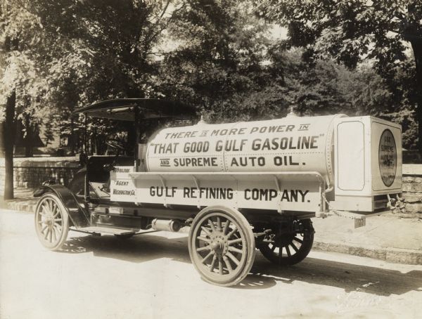 International Model F or 31 tanker truck operated by Gulf Refining Company.  Text on the truck reads: "There is More Power in 'That Good Gulf Gasoline' and Supreme Auto Oil."