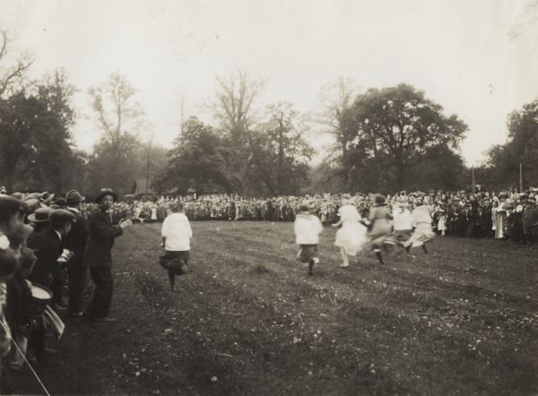 Students and teachers gathered in a field for the girls' relay race at an annual school festival in Belwood Park.
