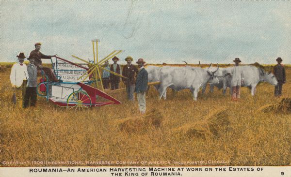 Postcard distributed by International Harvester Company featuring a color illustration of men in suits and farm laborers in a field next to a grain binder drawn by four oxen. Original caption reads: "Roumania — An American Harvesting Machine at work on the estates of the King of Roumania."
