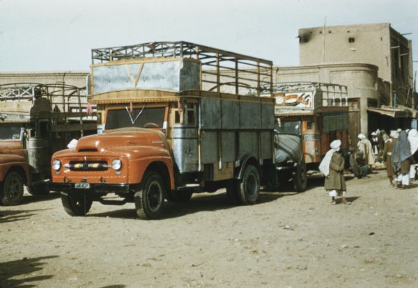 International Truck on a Street in Afghanistan International truck on a street in Afghanistan. Buildings and pedestrians are around the trucks.