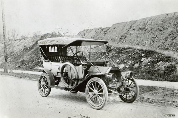 International Harvester J-30 Touring Car Original caption reads "1910-1911 International Harvester's only early sales success — and that a brief one — in the passenger car field was the J-30 Touring Car. Production was discontinued in 1912 when the decision was made to concentrate on truck manufacture. International J-30 Touring Car (I-1633-KK.)"
