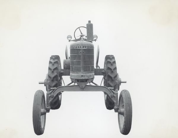 Farmall H Tractor Front view of Farmall H tractor with cane tractor attachment.