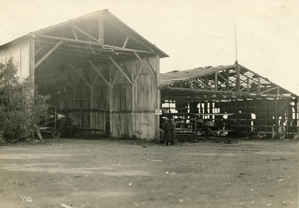 Hangars of the Curtiss Aviation School and the San Diego Aero Club on North Island in San Diego Harbor. Glenn Curtiss himself is thought to be the individual on the right.