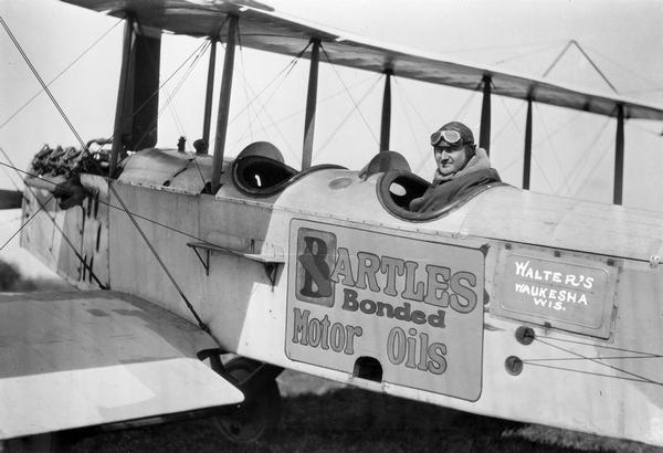 Walter Liskowitz of Waukesha in his two-place Standard. This photograph was taken shortly after he organized Walter's Airline to provide service to Chicago. Apparently he also found that his airplane made a good traveling billboard.