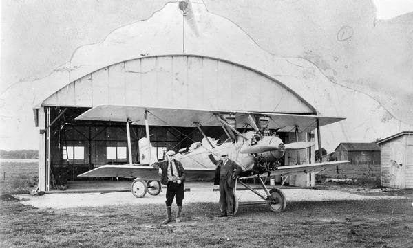 The second Sheboygan airport was built by owner Anton Brotz, Sr. after a fire destroyed his first hangar. Brotz is photographed here with his son, Anton, Jr., and a Woodson Express airplane. After wind destroyed the second hangar, Brotz moved his operation to Kohler, Wisconsin.