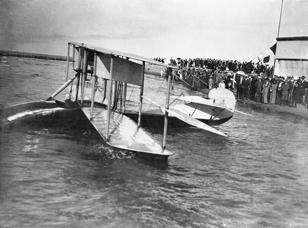 The Curtiss flying boat in which Jack Vilas made the first flight across Lake Michigan. Vilas, a Chicago businessman, was greeted by a crowd of aerial enthusiasts. His achievement was not only the first flight over the lake, but it was also the longest flight to date over water — even longer than Bleriot's crossing of the English Channel. In 1915 Vilas used the same airplane under contract with the state of Wisconsin to spot forest fires.
