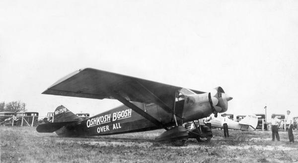 In order to undertake a trans-Atlantic flight to Norway, Clyde Allen Lee sought financial support from the local Oshkosh clothing company. The sign painted on the side reads: "Oshkosh B'Gosh Over All". Toward that end, he painted company advertising on the fuselage of his Stinson airplane, but the company lost interest. Ultimately, businessmen in Vermont offered support, and Lee repainted the plane before taking off. Clyde Allen Lee disappeared over the Atlantic during his flight to Norway in 1932.