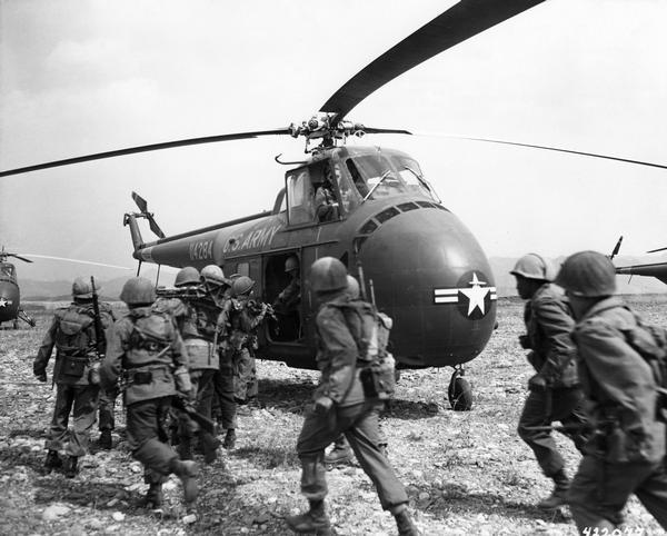 Infantry troops of the 8th Army preparing to board a Bell UH-1D helicopter of the 6th Transportation Helicopter Company for transport to the front.