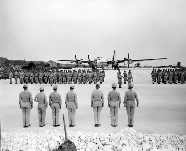 The medal ceremony for the crew of the <i>Enola Gay</i> held on Tinian Island after they dropped the  atomic bomb on Hiroshima.  The <i>Enola Gay</i>, B-29 Super Fortress bomber, is in the background.