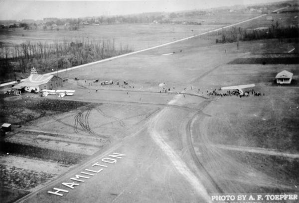 The airfield of the Hamilton Aero Manufacturing Company which became the site of Milwaukee County Airport in 1926. It was established by Thomas Hamilton, a local maker of airplane propellers who expanded his business to include  metal airplanes. The Hamilton field location is still part of the current, much expanded General Mitchell International Airport.