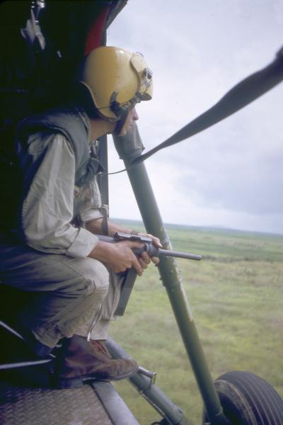 A photograph taken by Milwaukee photographer Dickey Chapelle on board a helicopter that was enroute to Vinh Quoi in the Delta Region of South Vietnam. The crew was following reports of a North Vietnamese raid in Vinh Quoi.