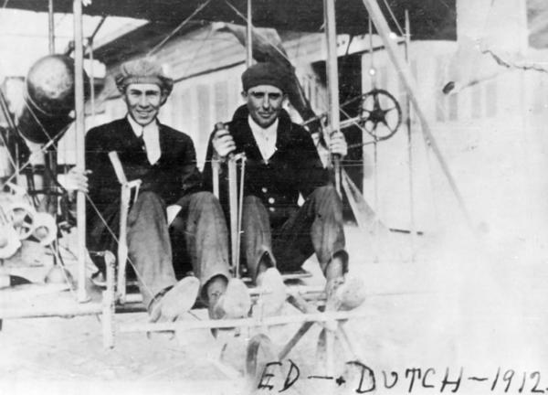 Cicero Field flight instructors Edward Finan (left) and DeLloyd Thompson seated in a Wright Model B airplane at the Chicago International Air Show. The plane is outfitted with dual controls for teaching purposes.