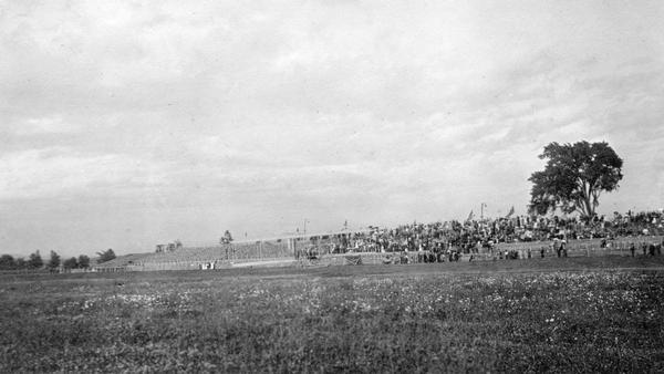 The grandstand at the Los Angeles Aviation Meet, the first international aviation event held in the United States. The plane on the ground near the center is the British-built Farman flown by Louis Paulham. Although several planes were present at Los Angeles, only Glenn Curtiss and Paulham were able to get into the air. Arthur P. Warner, Wisconsin's first aviator, attended the event and served as timer.