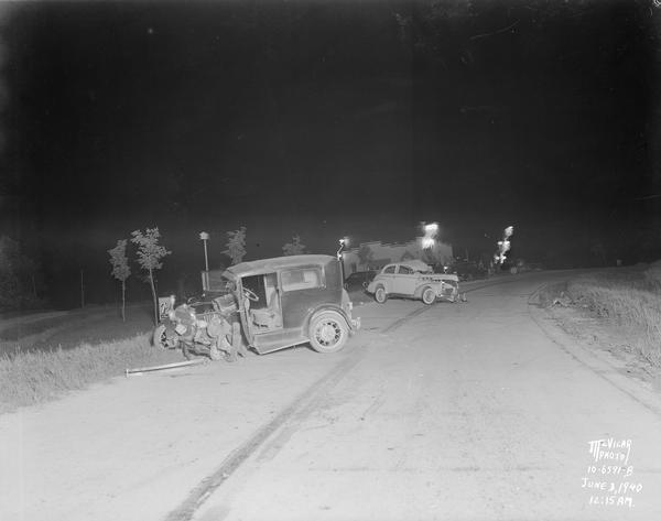 Accident scene on Highway 51, about 6 miles southeast of Stoughton. Damaged Ford is in foreground and Pontiac in background.