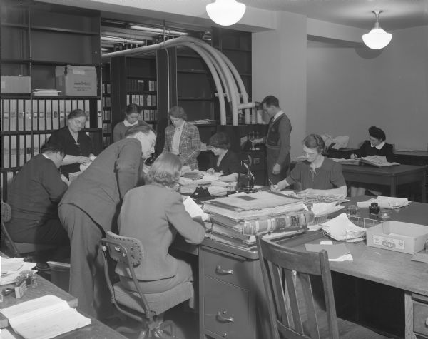 A group of employees records birth records in the Vault Room in the State Office Building (Capitol Annex), 1 West Wilson Street.