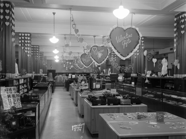 Main floor of Manchester's Department Store with valentine heart decorations and merchandise displays.