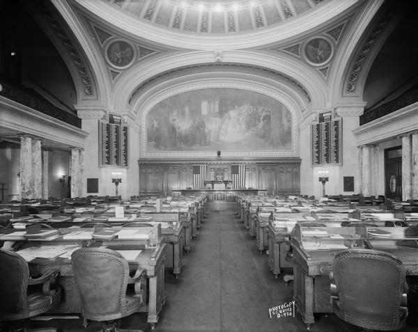 Interior view of the Assembly Chamber at the Wisconsin State Capitol, with seating for legislators, featuring the Edward Blashfield mural: "The State of Wisconsin, its Past, Present, and Future."