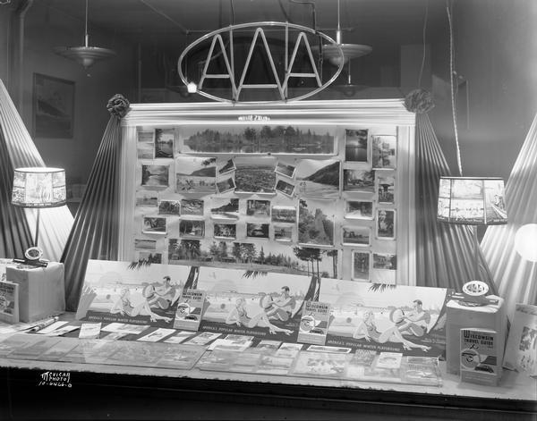 American Automobile Association display window showing Wisconsin travel brochures and pictures of tourist destinations around the state.