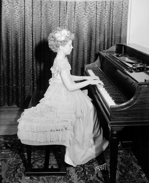 Juliette Gerke, a 9-year-old twin, playing the piano.