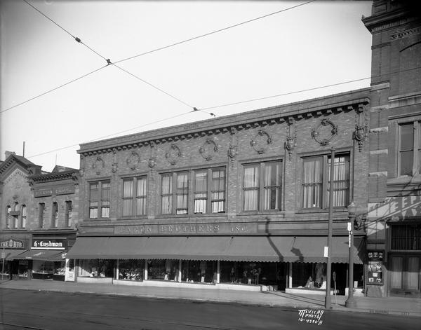 Baron Brothers department store, 12-18 W. Mifflin Street, also known as the Mendota Building, and The Hub, 22-24 W. Mifflin Street, and H. Cushman shoes (part of Baron Brothers store). The Parkway Theatre is on the far right.